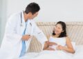 A doctor is checking a pregnant woman (illustration)