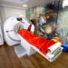 Patient undergoing CT Scan in Gurugram at a modern diagnostic lab with technician operating the scanning machine